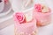 Two mini cakes with roses on a white table. Romantic dinner concept