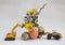 Two models of a toy excavator with an Easter composition of spring flowers in a shell and quail eggs