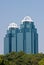 Two Modern Blue Office Towers Rising From Trees