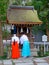 Two Monks standing in front of a Sessha at Izanagi Shrine