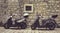Two Mopeds in front of the Wall