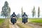 Two Motorcycle Drivers Riding Custom Chopper Bikes on an Autumn Dirt Road in the Green Field. Adventure Concept.