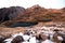 Two mountain tarns in alpine environment of New Zealand Alps with peak above them in autumn with little snow. Angelus lakes,