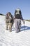 Two mountaineers with large backpacks during a winter
