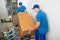 Two Movers With Box On Staircase