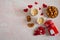 Two mugs of hot coffee with marshmallows, cookies in the form of hearts, a gift box and decorative hearts on a background of pink