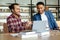 Two multicultural male students studying with laptop