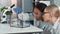 Two multiracial female scientists showing amazement during providing experiment with lab hamster