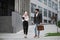 Two muslim office workers walking talking outdoors