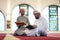 two muslim people in mosque reading quran together concept of islamic education