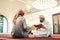 two muslim people in mosque reading quran together concept of islamic education