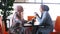 Two muslim women drink coffee and communicate