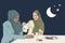 Two muslim women serving tea and eating arabic sweets during ramadan.