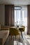 Two mustard yellow chairs standing by round table in spacious kitchen