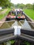 Two narrowboats in a canal lock