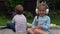 Two naughty Siblings dont share. boy ans girl listening to music on headphones outside. Children and technology. Brother