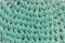 Two-needle knit fabric with turquoise wool yarn in close-up detail