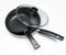 Two new empty frying pans with a lid, top view, on a white background