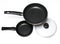 Two new empty frying pans with a lid, top view, on a white background.