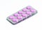 Two new packs of 10 pink oblong pills isolated on a white background