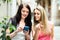 Two nice girls finding path with smartphone