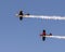 Two North American Aviation T-6 flying over Duck Creek with other Warbirds prior to the traditional fireworks display.