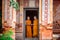 Two novices are standing reading books together in the temple. T