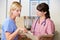 Two Nurses Discussing Patient Notes At Nurses Station