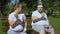 Two obese people eating apples after jogging, weight loss diet, organic food