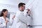 Two odontologist researchers studying dental anatomy on a whiteboard.