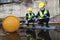 Two Officers of Environmental Engineering Wearing Protective Equipment with Gas Masks Inspected Oil Spill Contamination in