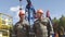 Two oil workers overseeing drilling rig of crude oil production. Industrial oil well pump jacks pumping crude oil for