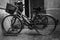 Two old bicycles park in the backyard of an old building