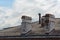 Two old chimneys on roof of an apartment house