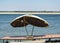 Two old, fitted by cloth, straw parasols closed from the midday sun the place Brahmin on the banks of the Ganges River in Varanasi