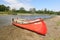Two old red canoes (boats) on the bank of the Morava River, Europe