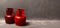 Two old red gas cylinders are standing on the floor