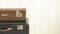 Two old retro suitcases White wooden background Vintage tinting