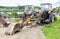 Two old rusty disassembled tractors in a Russian village