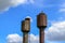 Two old rusty metal water towers in the village