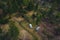 Two old vintage custom offroad campervans parked in the morning hours on the forest plain. Drone view of adventurous night with a