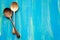 Two Old vintage spoons on blue wooden background, top view