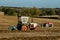 Two old vintage tractors ploughing