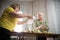 Two old women making little apple pies. Sifting the flour