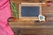 Two old wooden cooking spoons with fresh rosemary twigs and an old slate blackboard