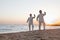 Two older people practicing Taijiquan on the beach at sunset, China