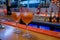 Two orange alcoholic spritz cocktails sitting on bar counter