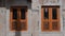 Two orange bedroom windows on a white wall