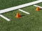 Two orange cones between hash marks on football field