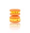 two orange homemade macarons stack isolated on white